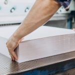 Man working in printing house with paper and paints